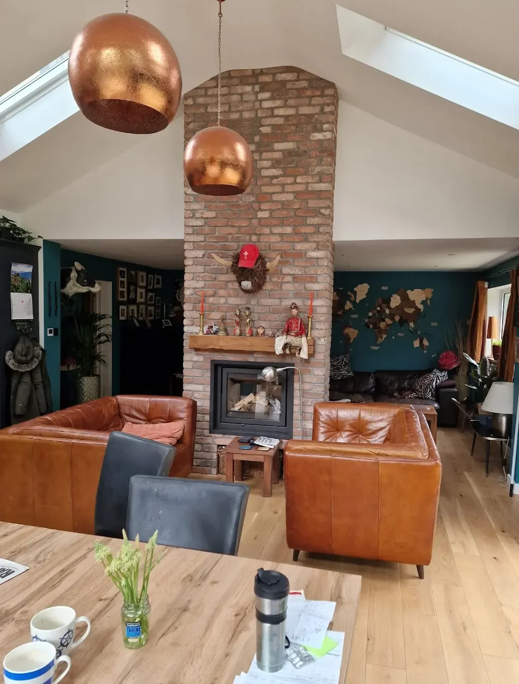 Interior renovation with exposed brick fireplace and vaulted ceiling by Roman City Construction